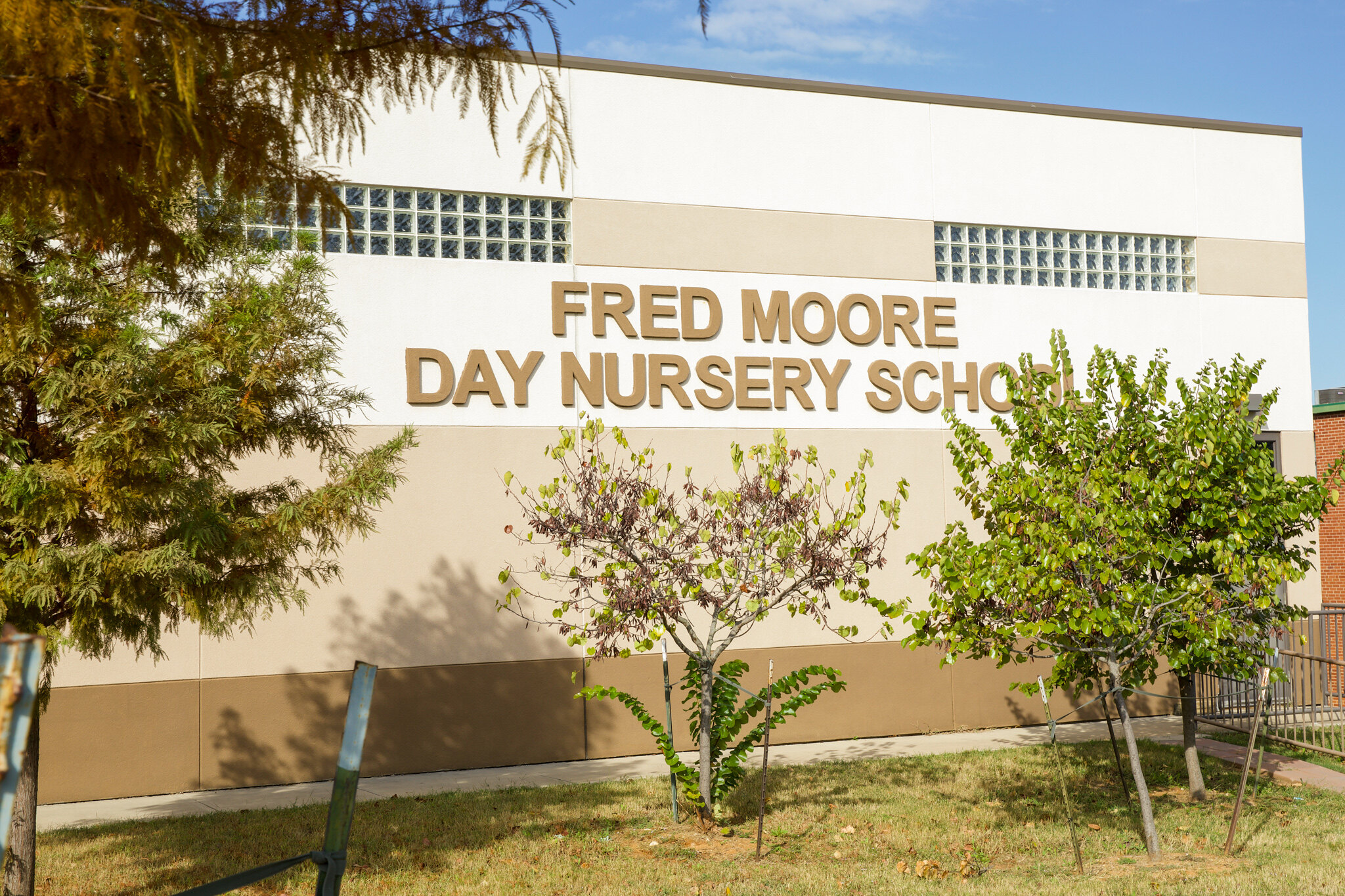FMDNS Signage outside with overgrown trees
